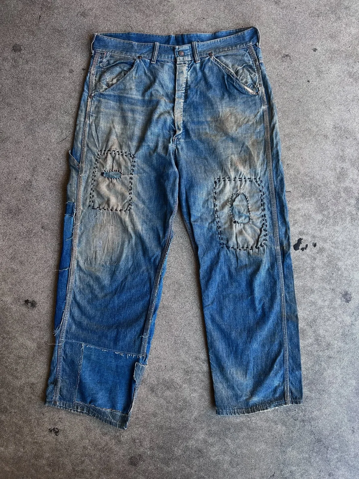 Blue work pants with patched knees and visible stitching