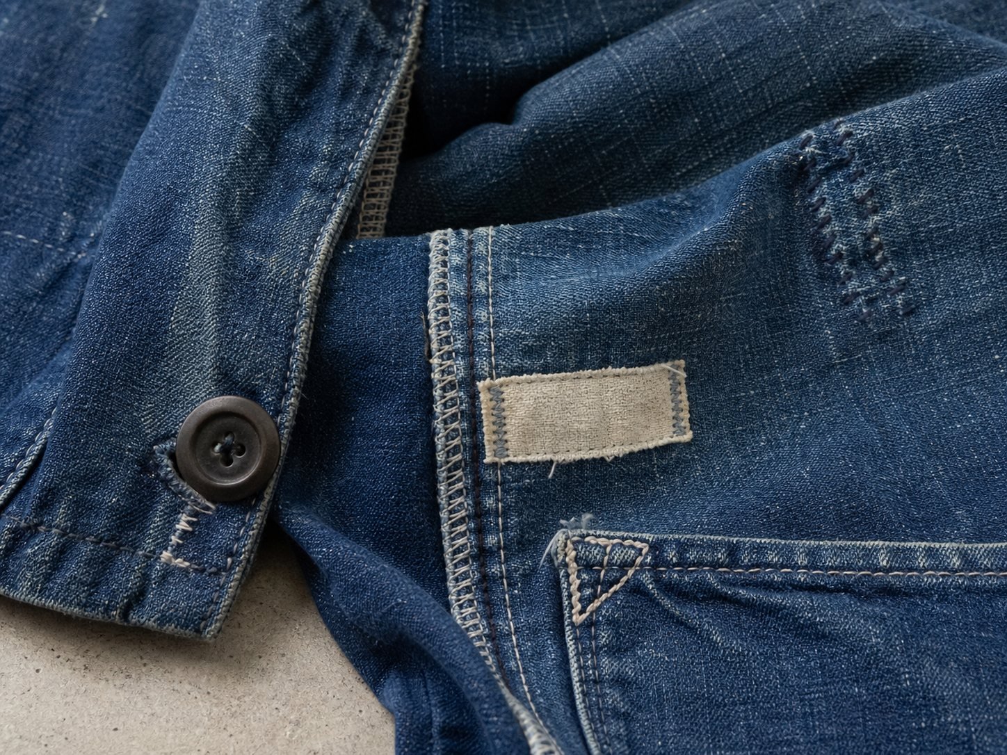 Representative close view of worn fabric, stitching, and garment hardware